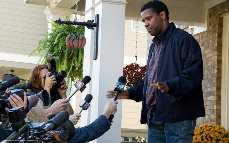 man speaking to reporters