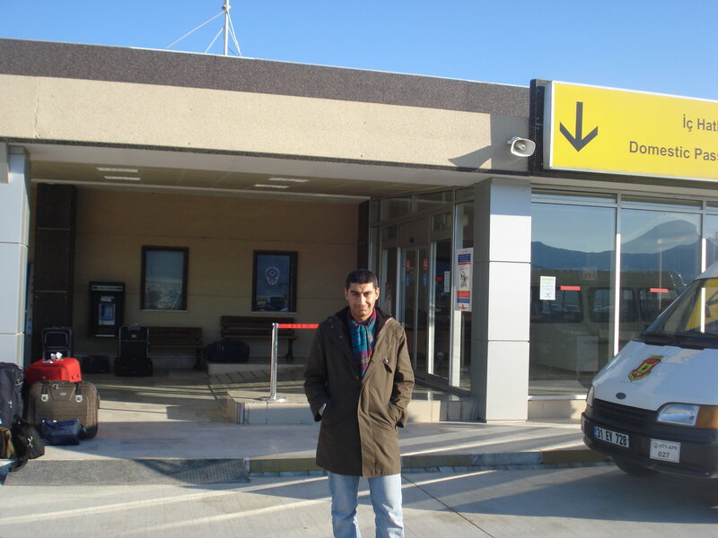 man standing at airport entrance