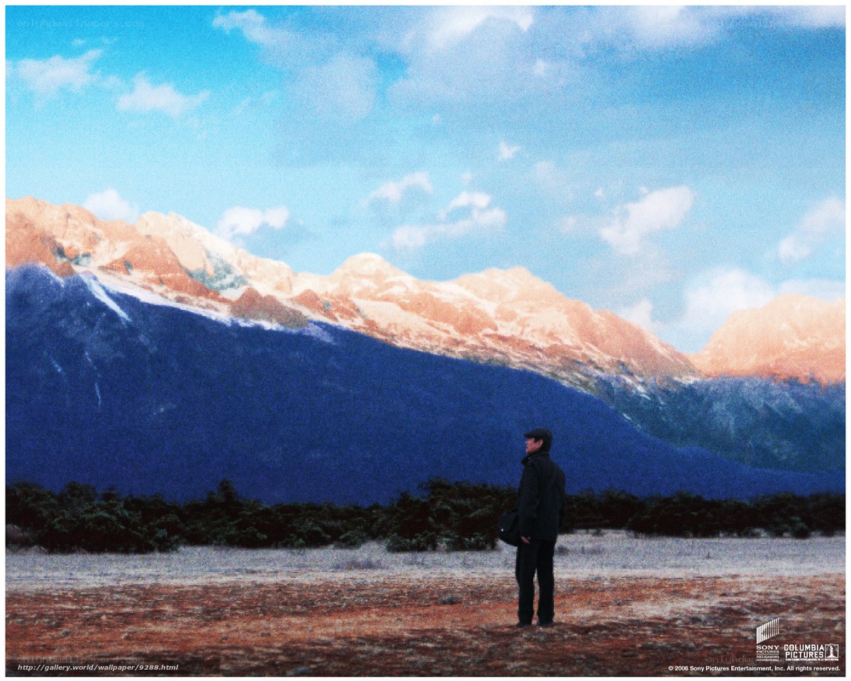 Man standing before mountains