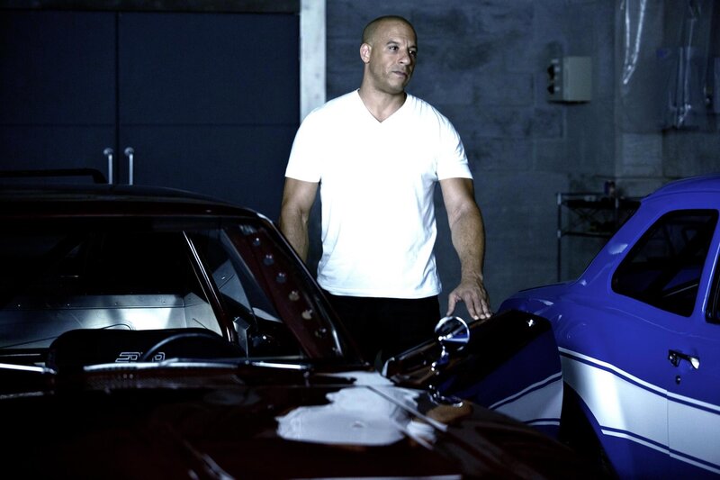 Man Standing Between Cars