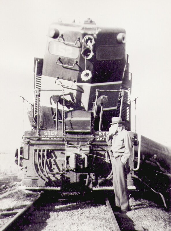 Man standing by a train engine