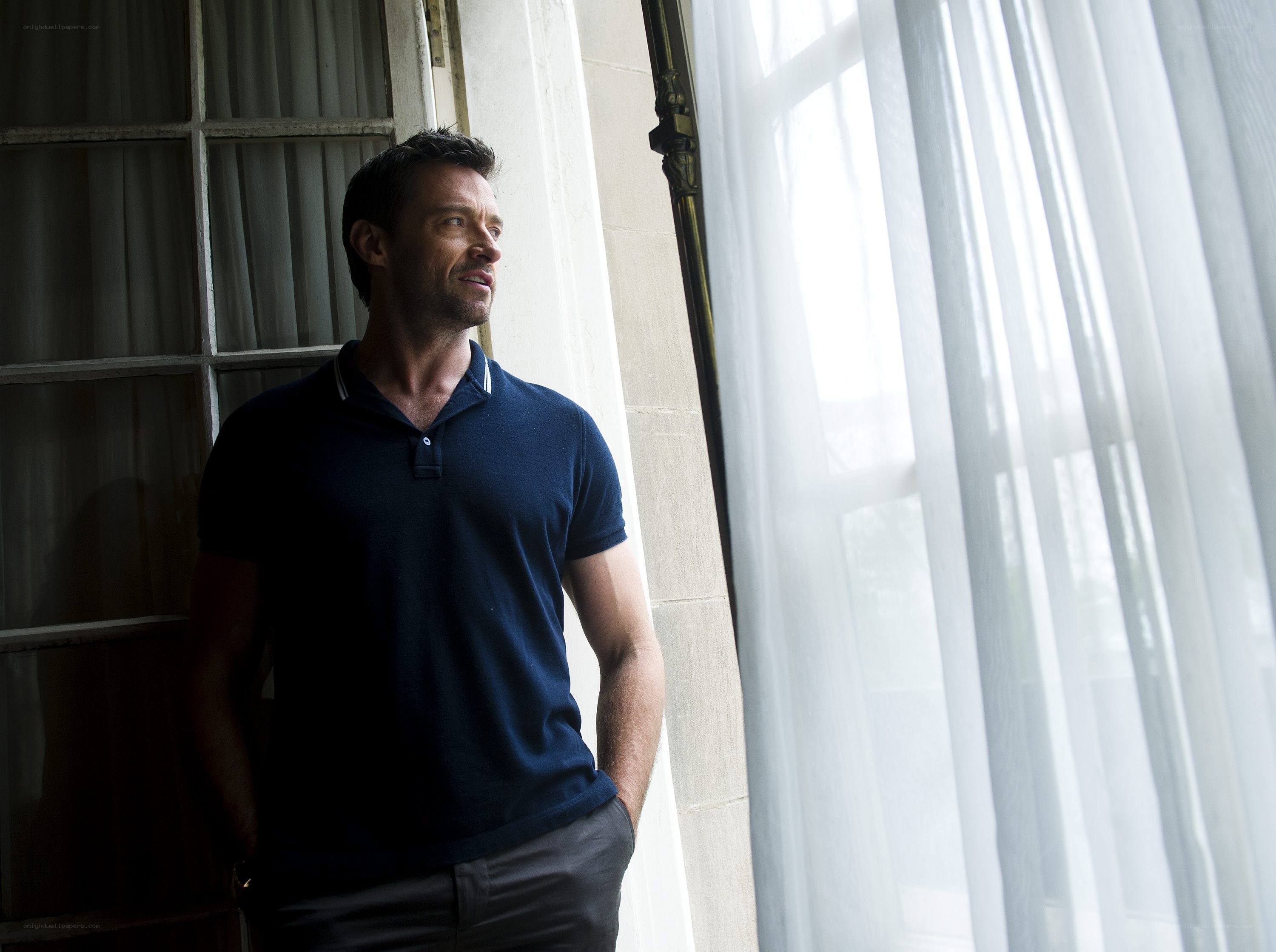 man standing by a window