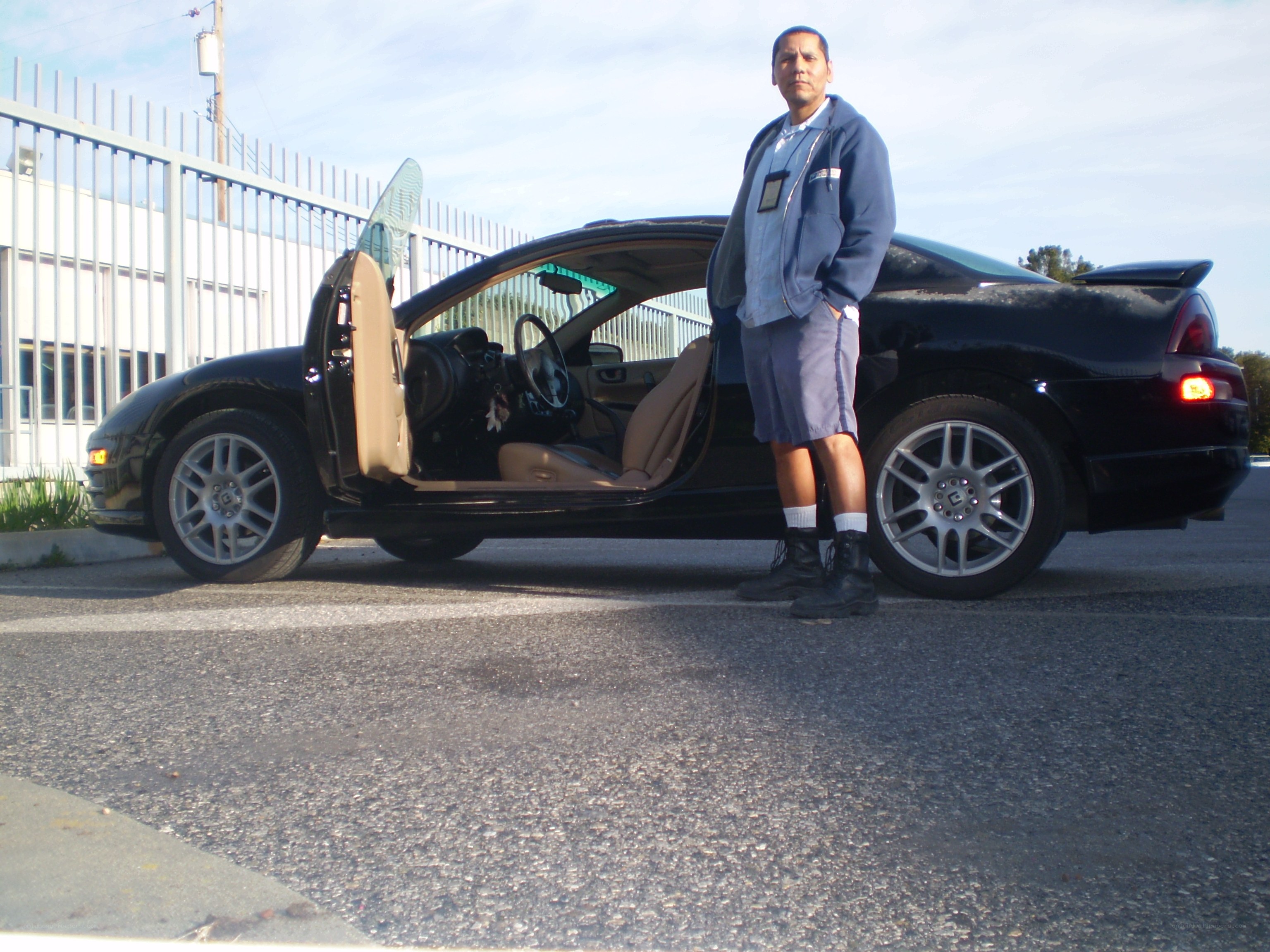 Man standing by black car