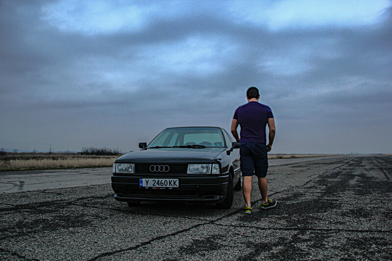 Man Standing by Car — Gray, Dramatic