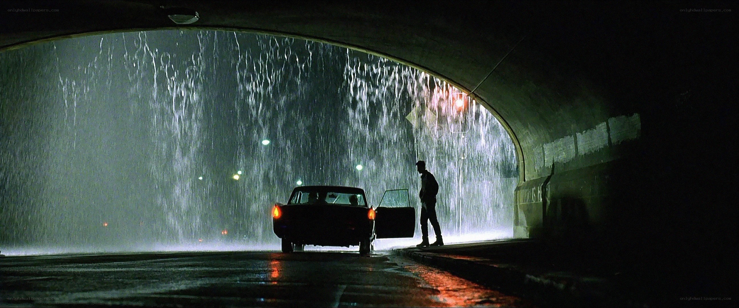 Man standing by car in tunnel