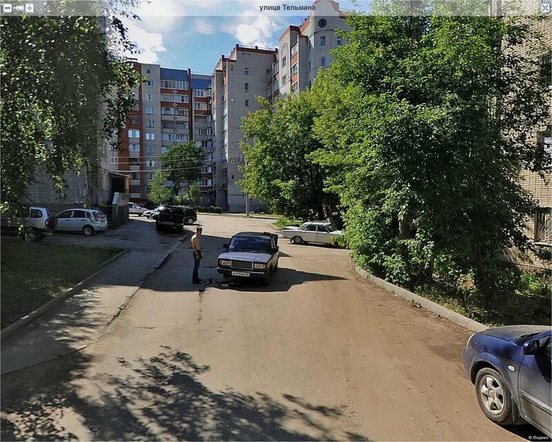 Man standing by car on street