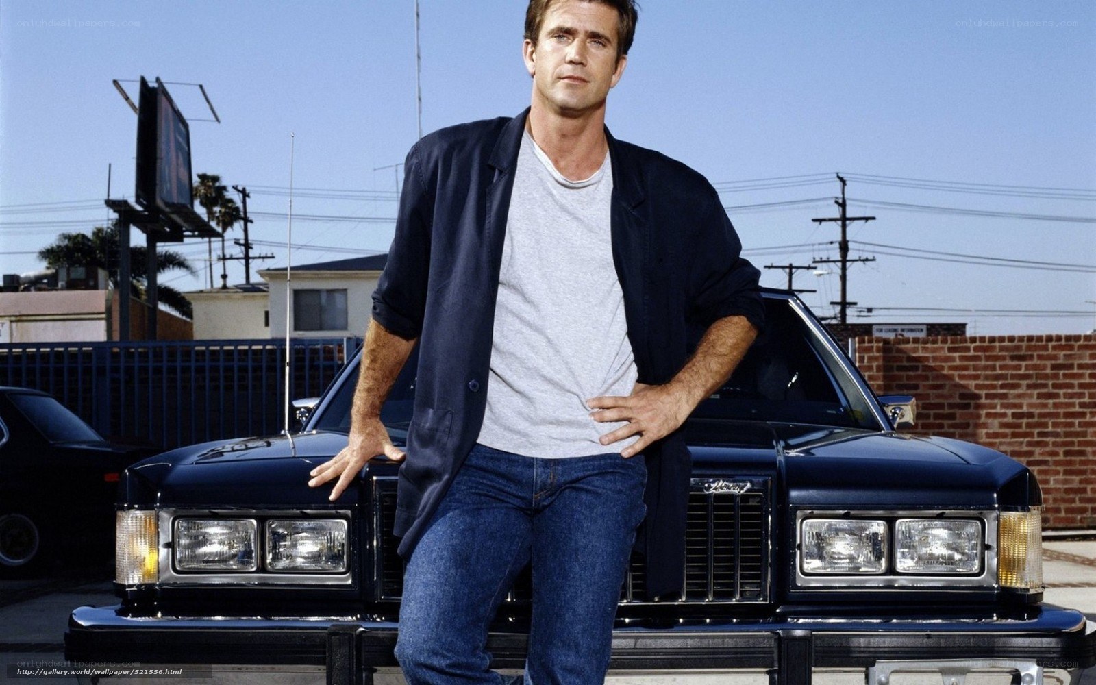 man standing by classic car