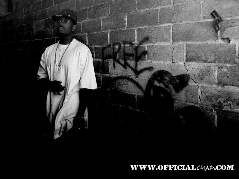 man standing by graffiti wall