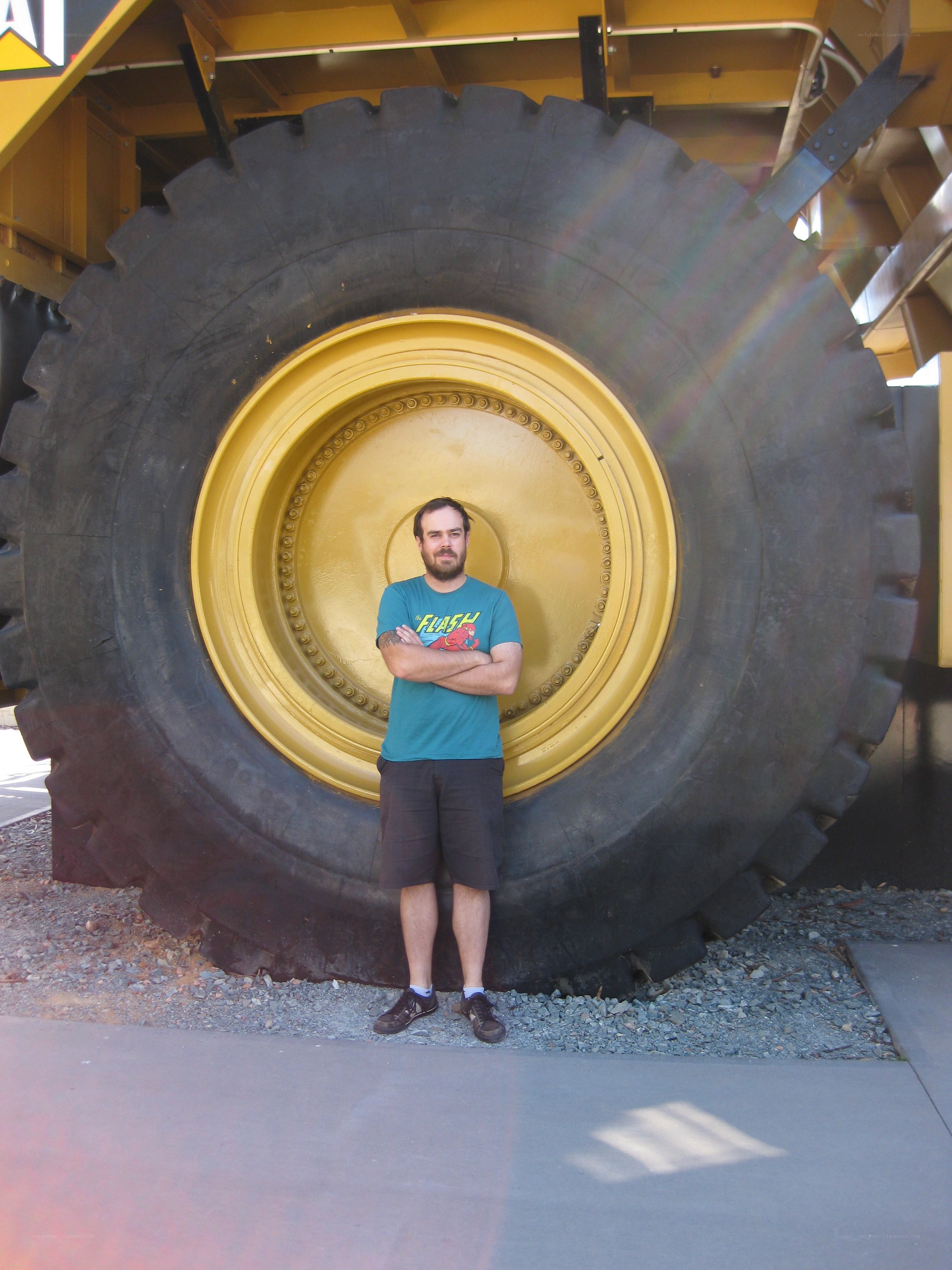 Man standing by large tire