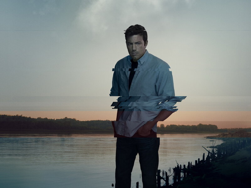 man standing by river at dusk