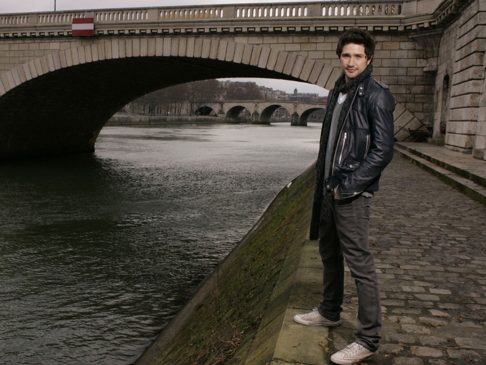 man standing by river in paris