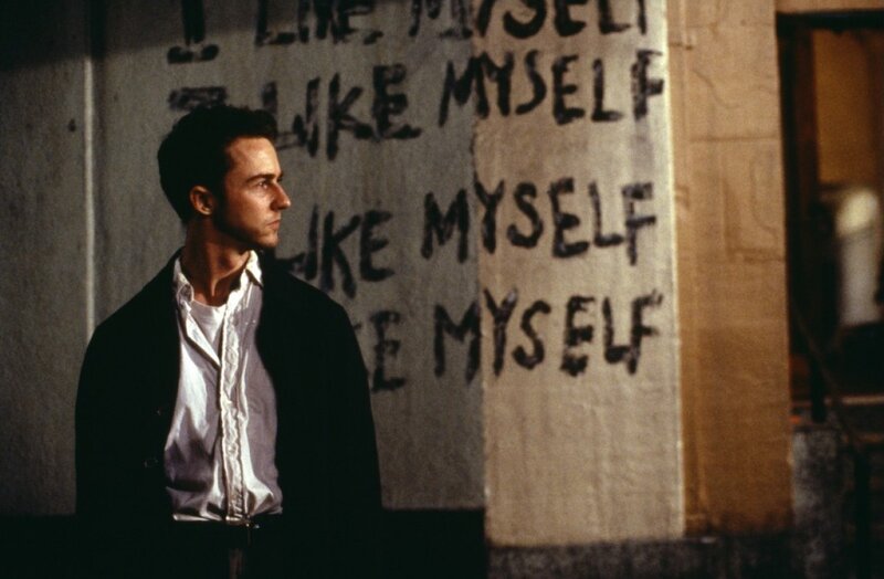 Man Standing by Wall