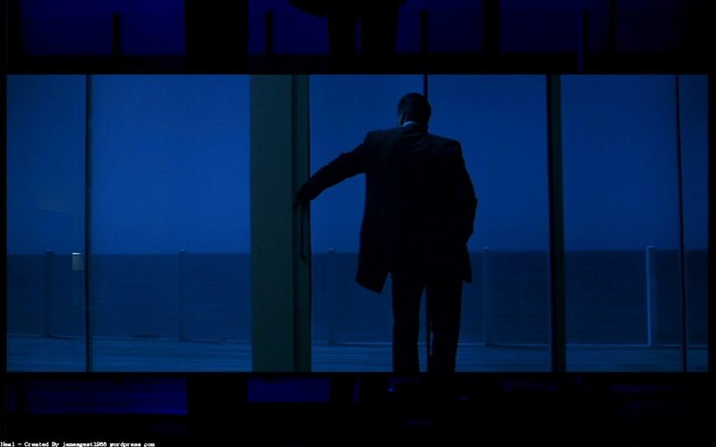 man standing by window at night