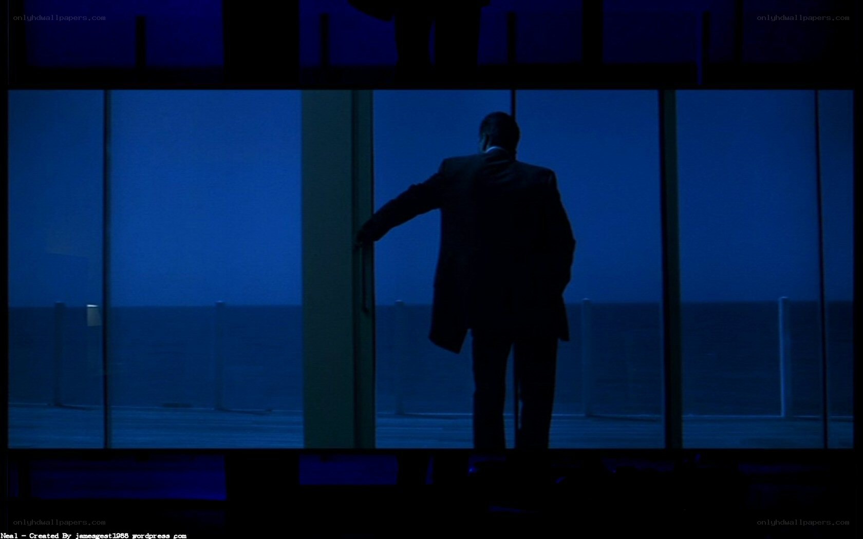 man standing by window at night