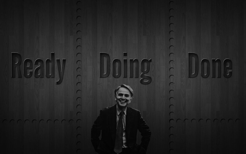 Man standing in front of 'Ready Doing Done' sign