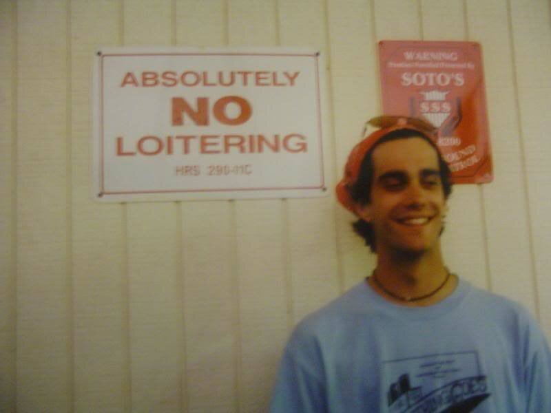 Man Standing in Front of Signs