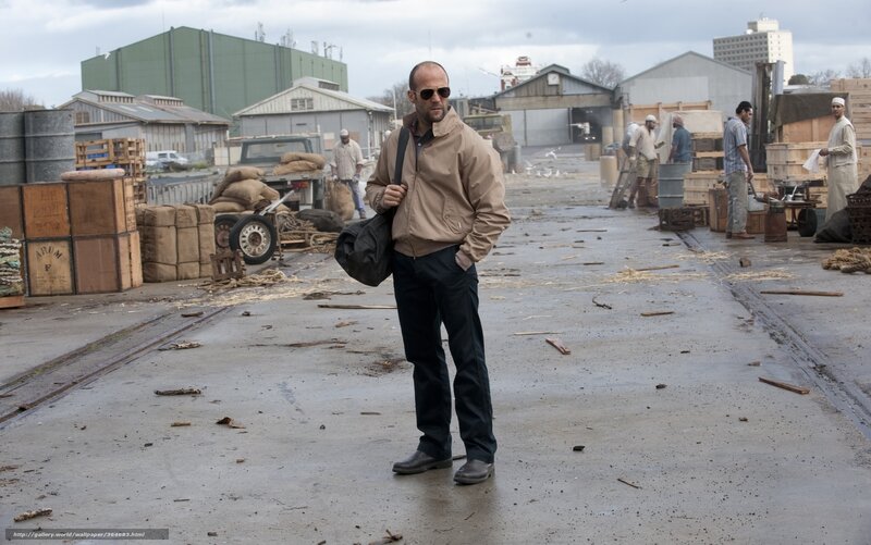 man standing in industrial yard