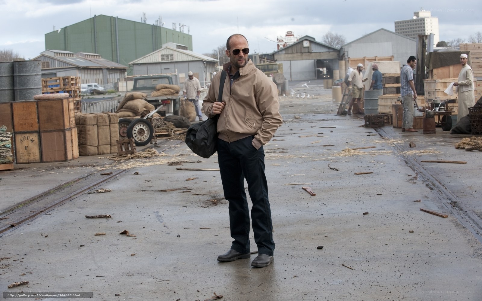 man standing in industrial yard
