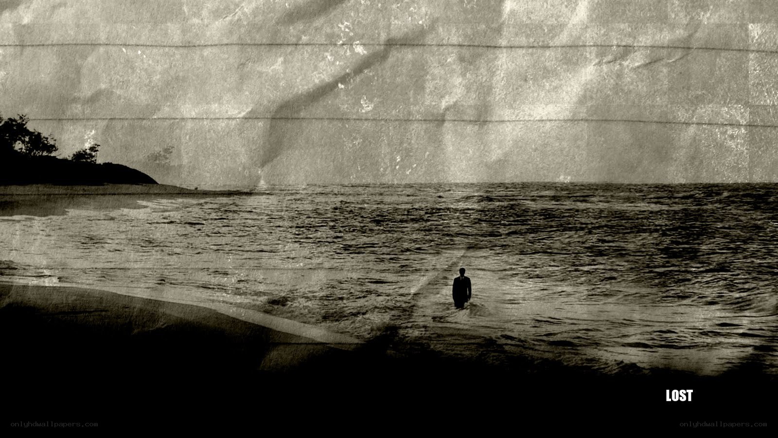 man standing in ocean at dusk