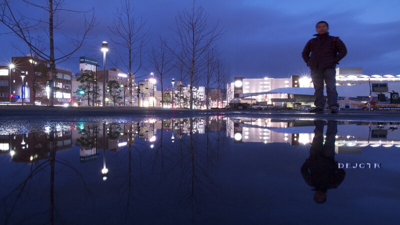 Man Standing in Puddle — Blue