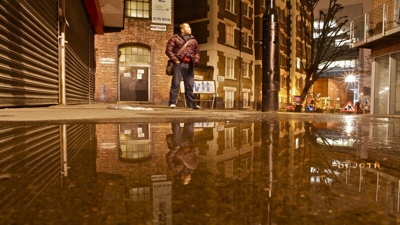 Man Standing in Puddle