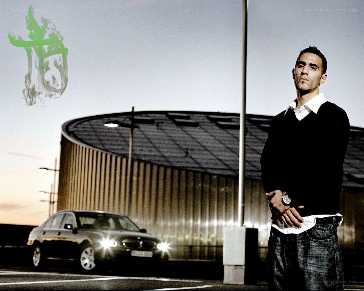 Man standing near car at dusk