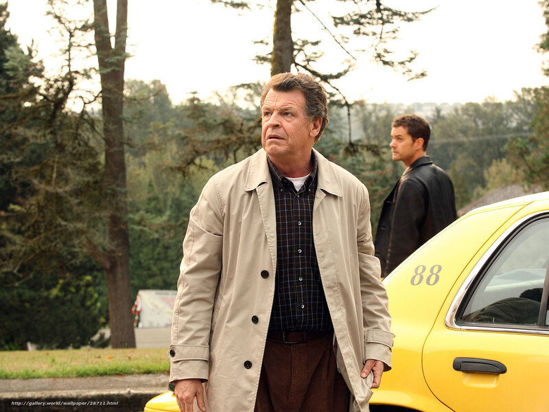 man standing near yellow car