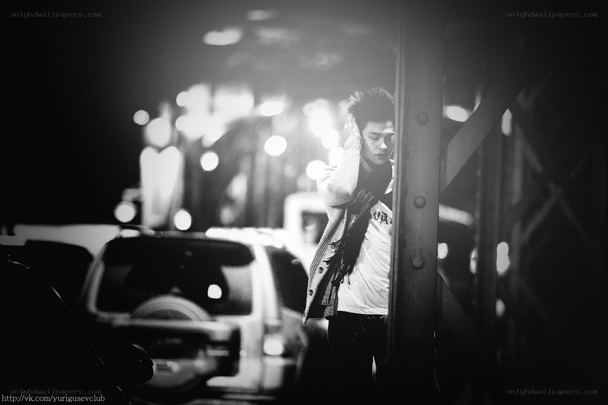 man standing on a bridge at night