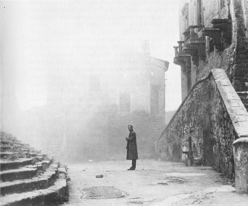 man standing on a foggy street