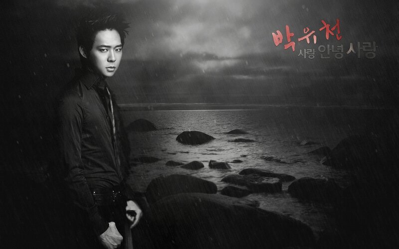 Man Standing on Rocky Shore