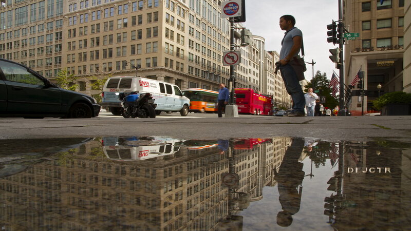 Man Standing on Sidewalk