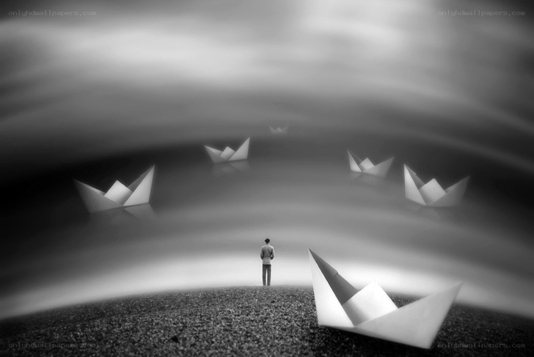 man standing with paper boats
