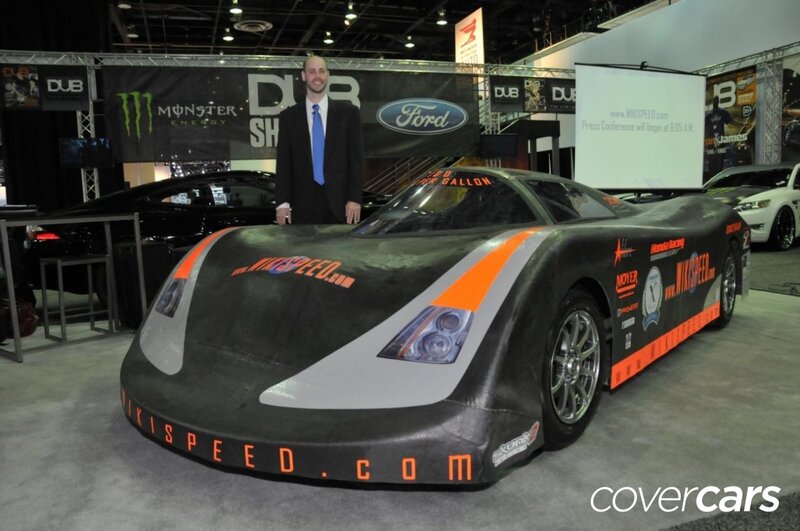 Man Standing with Race Car