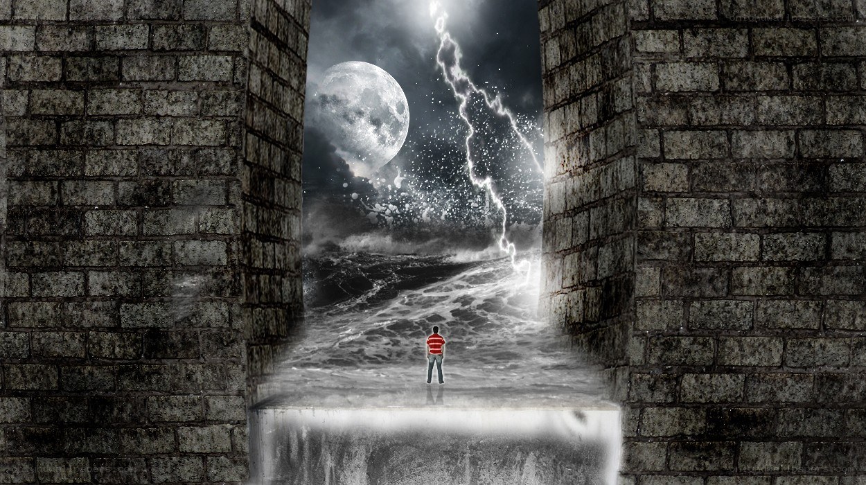 Man stands before stormy portal