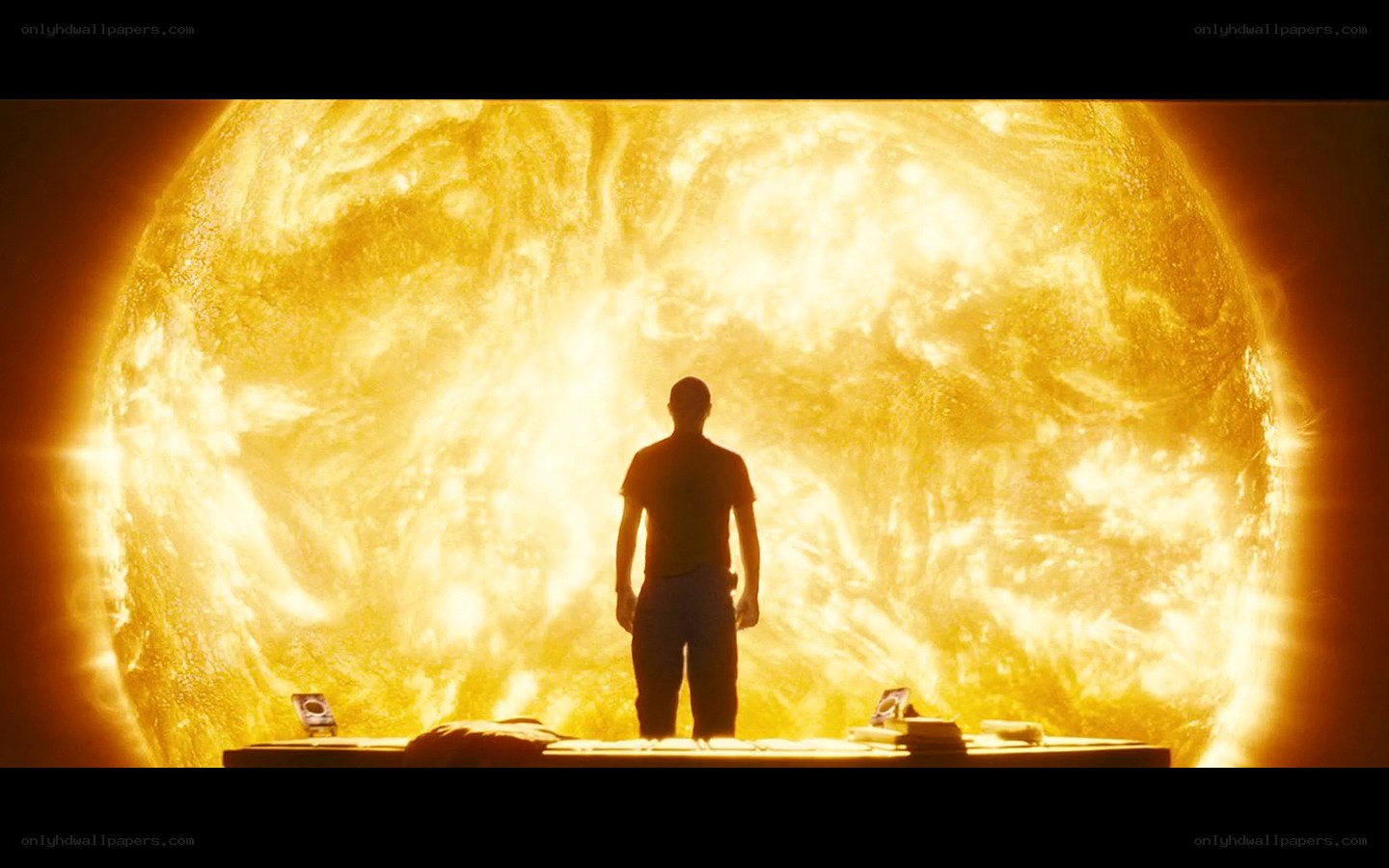 man stands before sun