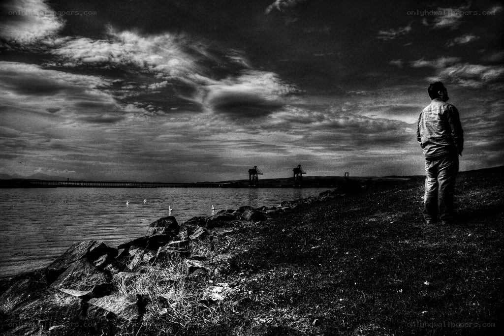Man stands by the water