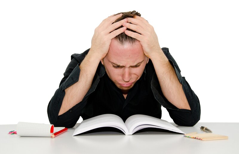 man stressed over book