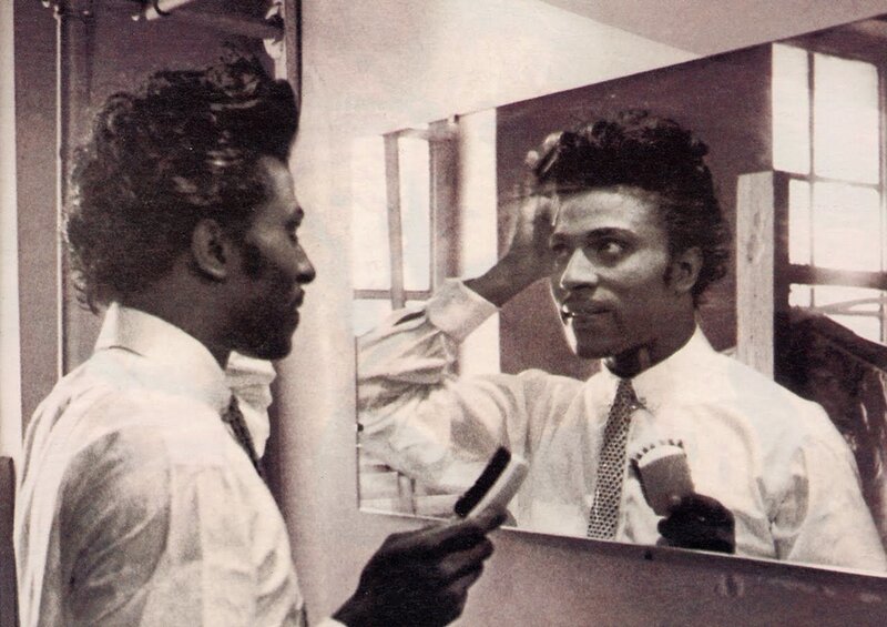 man styling hair in mirror
