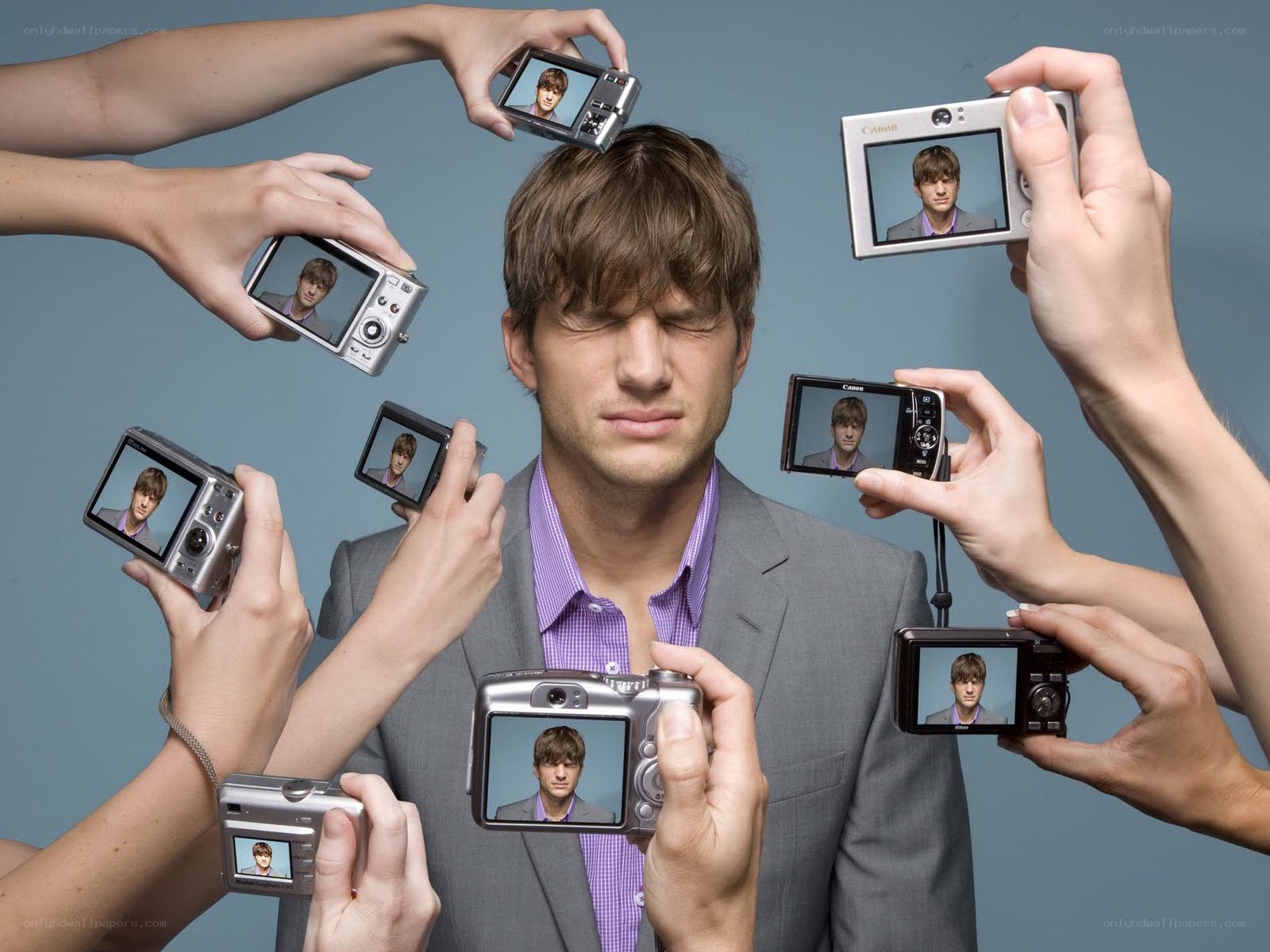 man surrounded by cameras