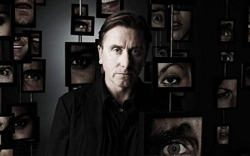 man surrounded by faces
