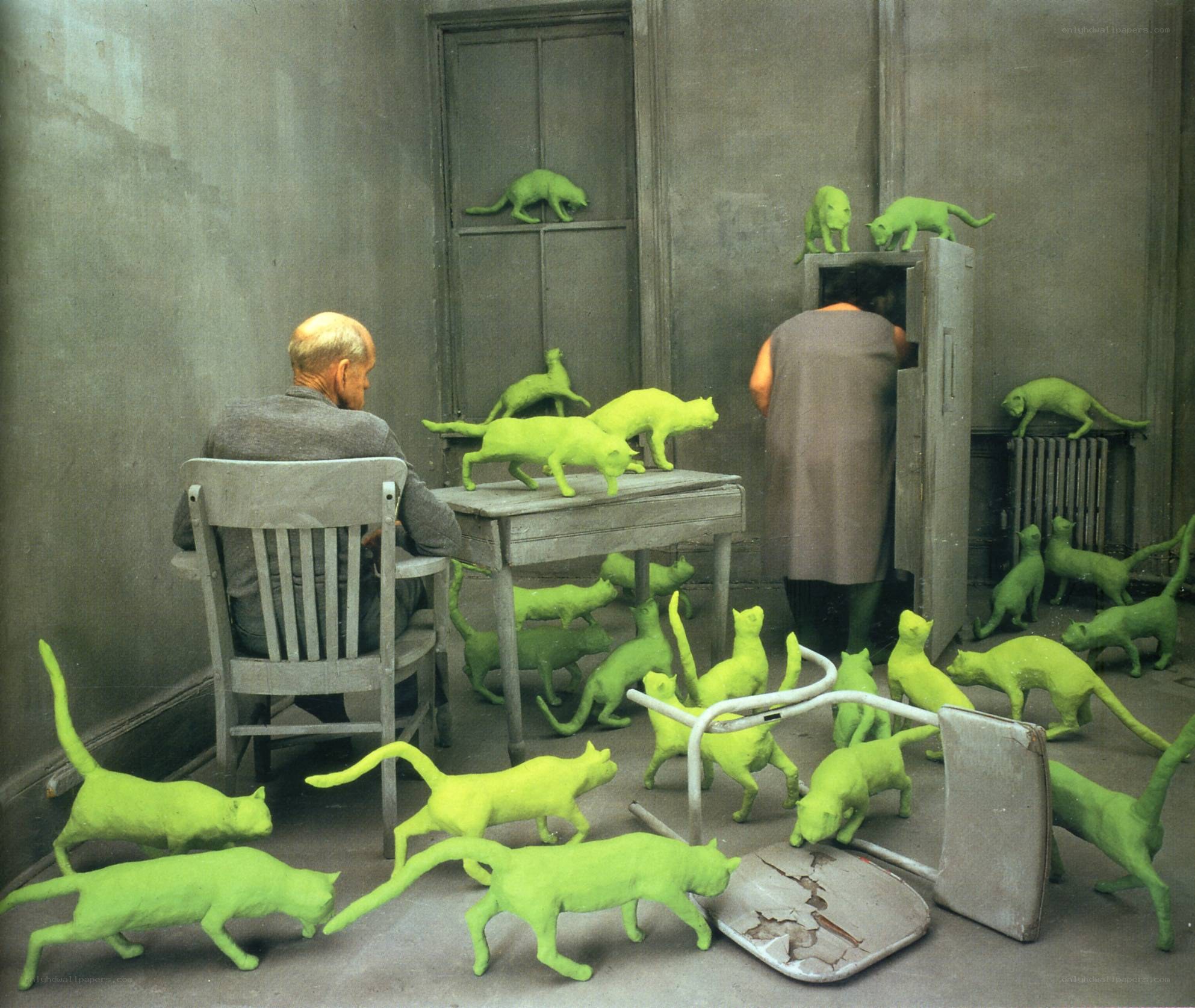 Man surrounded by green cats