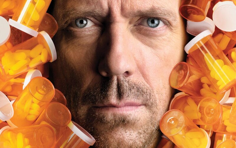 Man Surrounded by Pill Bottles — Orange