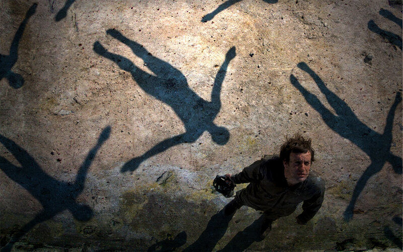 Man surrounded by shadow figures