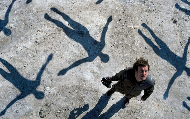 Man surrounded by shadows