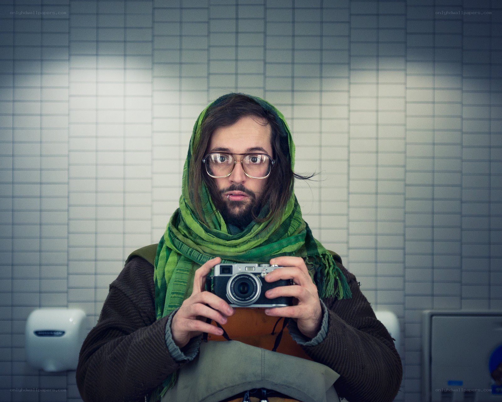 man taking mirror selfie in bathroom