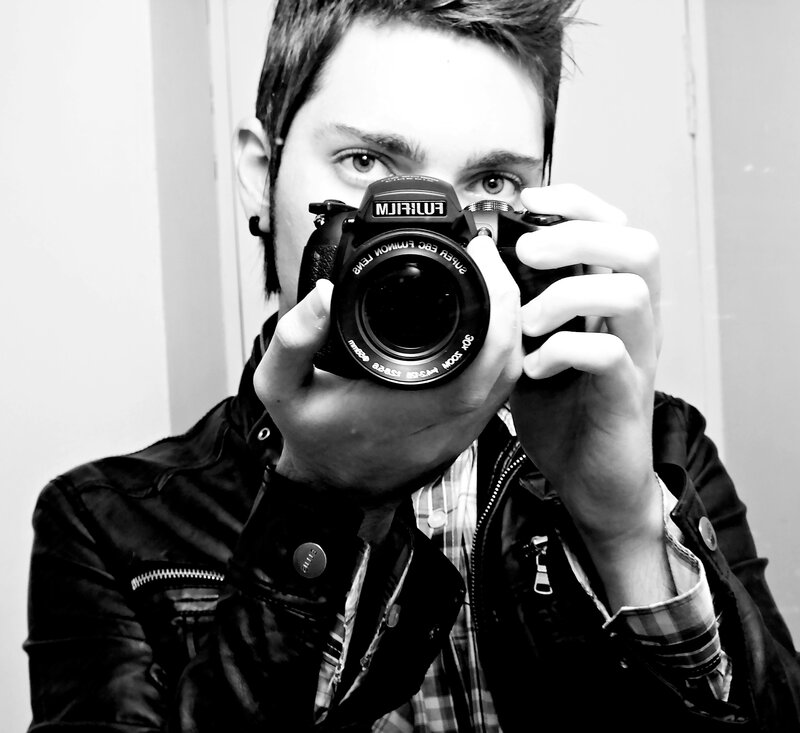 man taking mirror selfie with camera