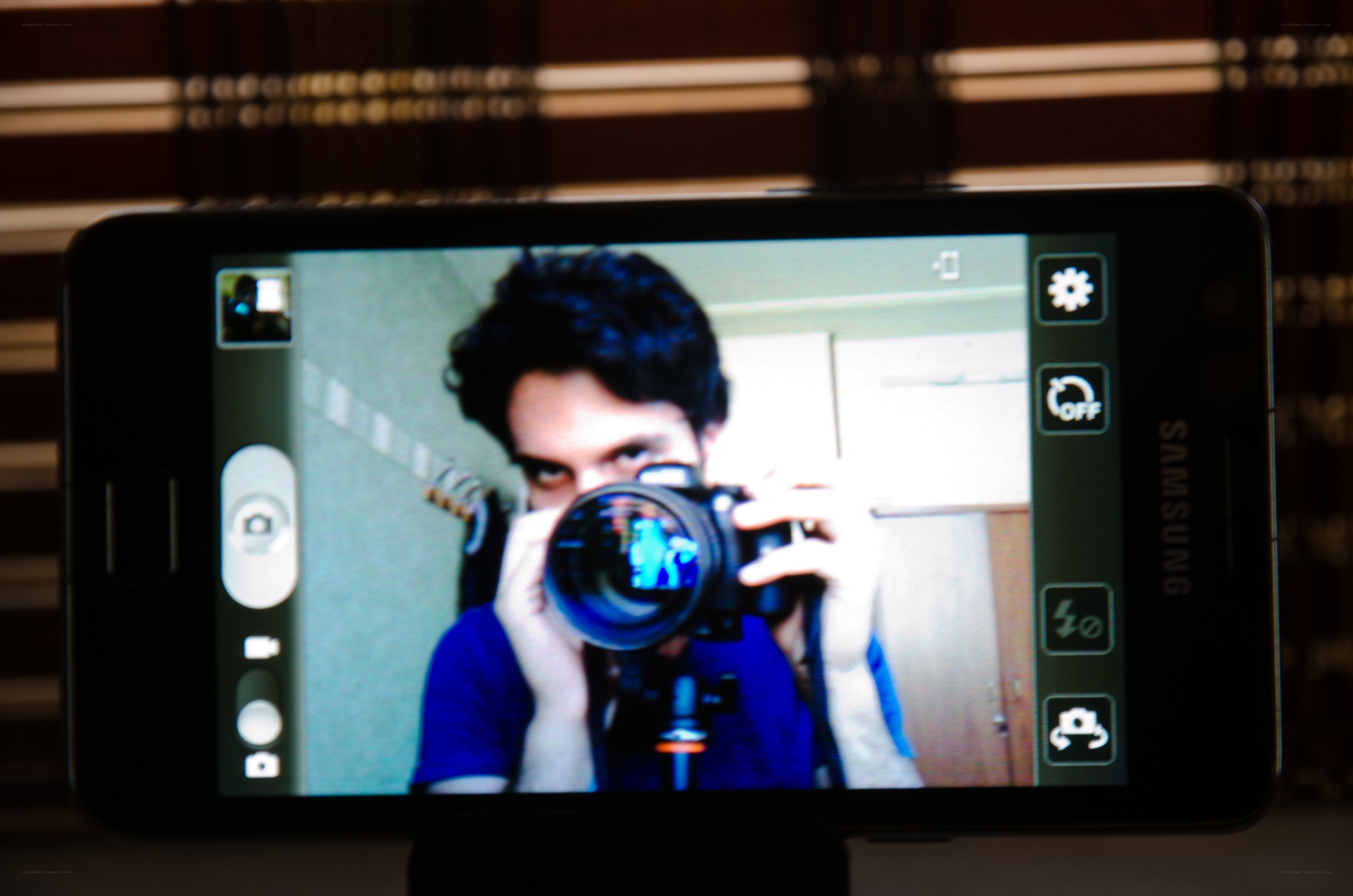 man taking mirror selfie with camera
