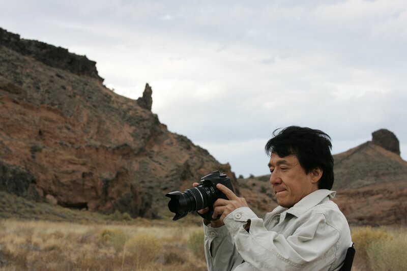 man taking photo in desert