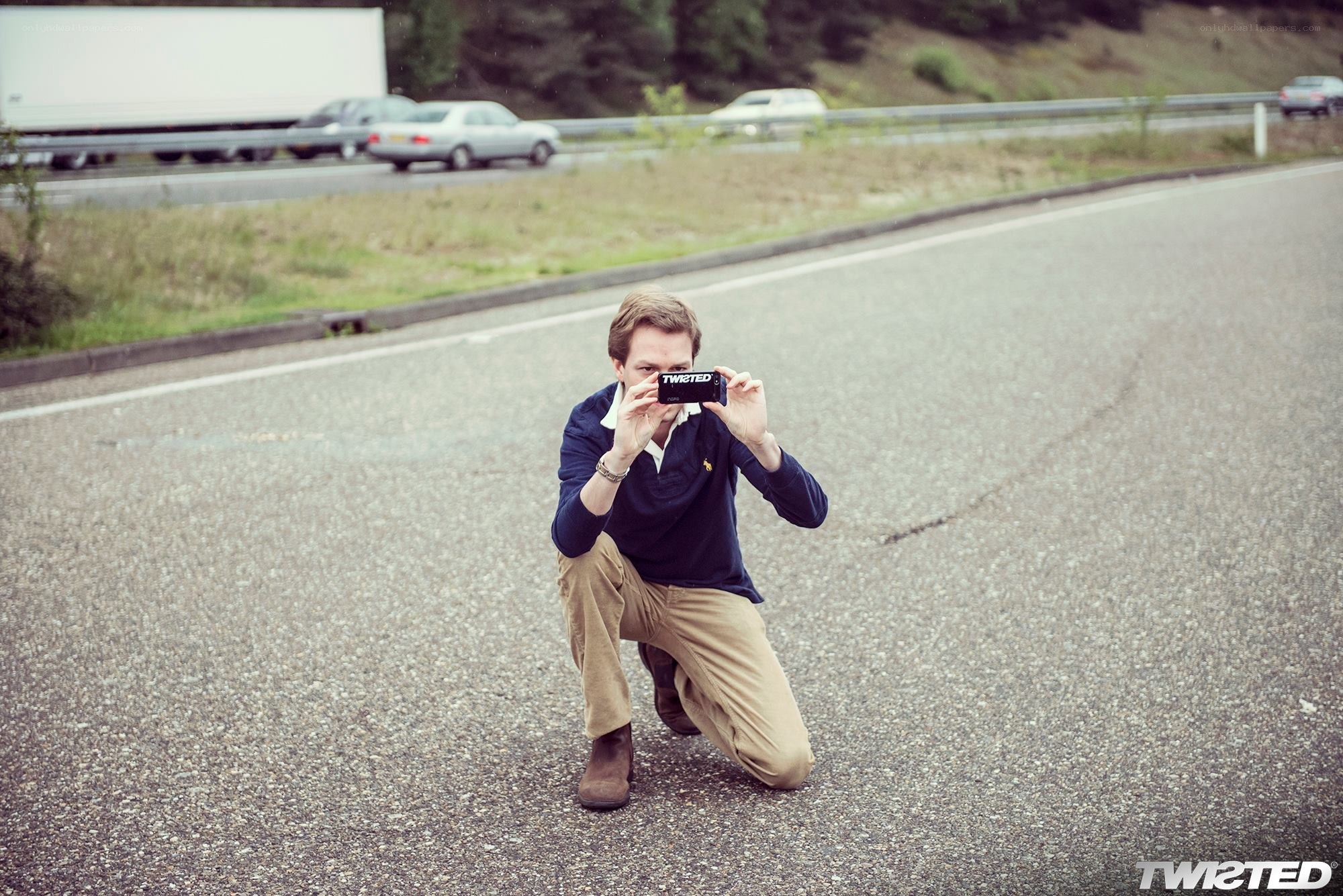 man taking photo on road