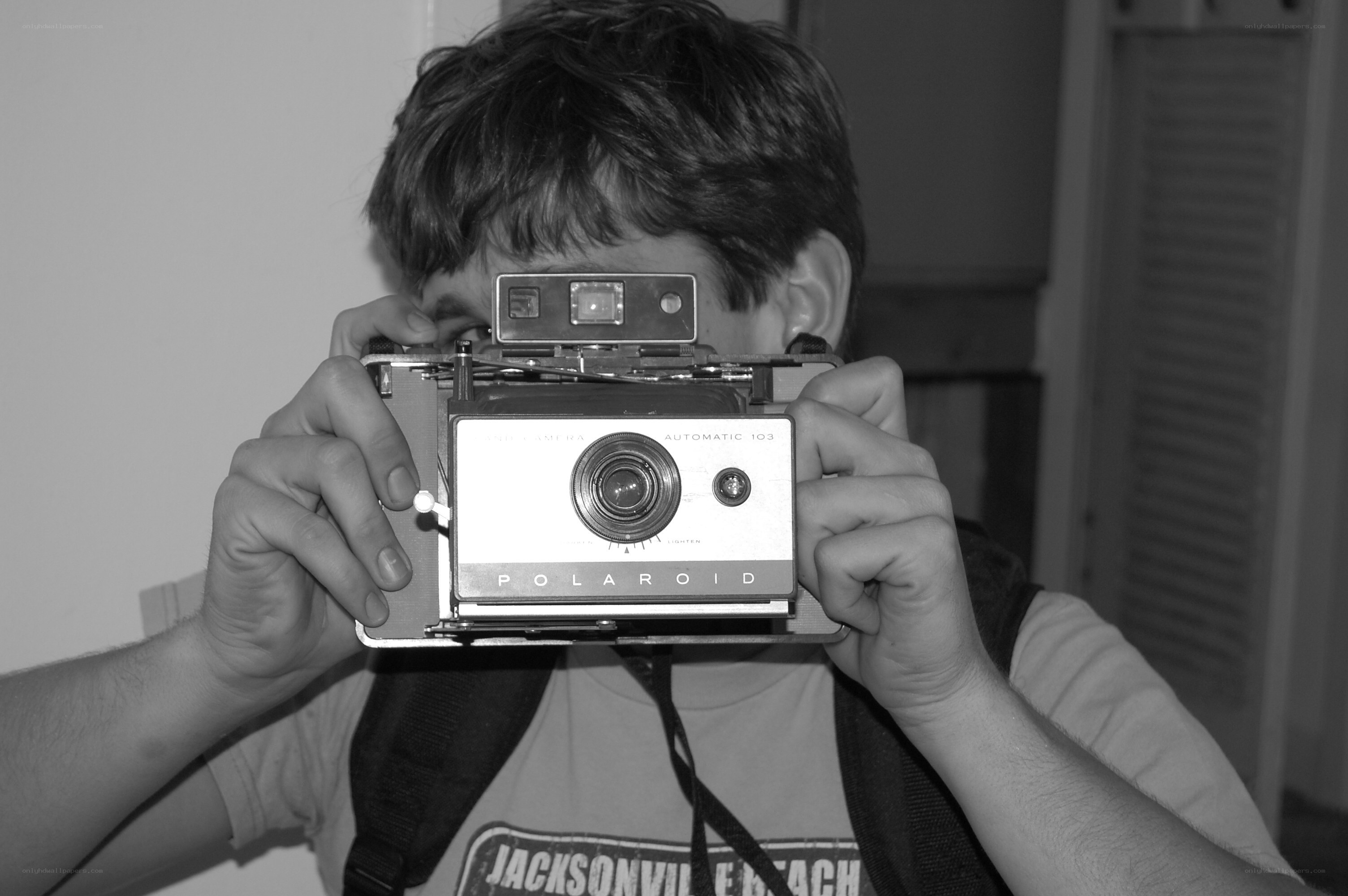 man taking photo with polaroid